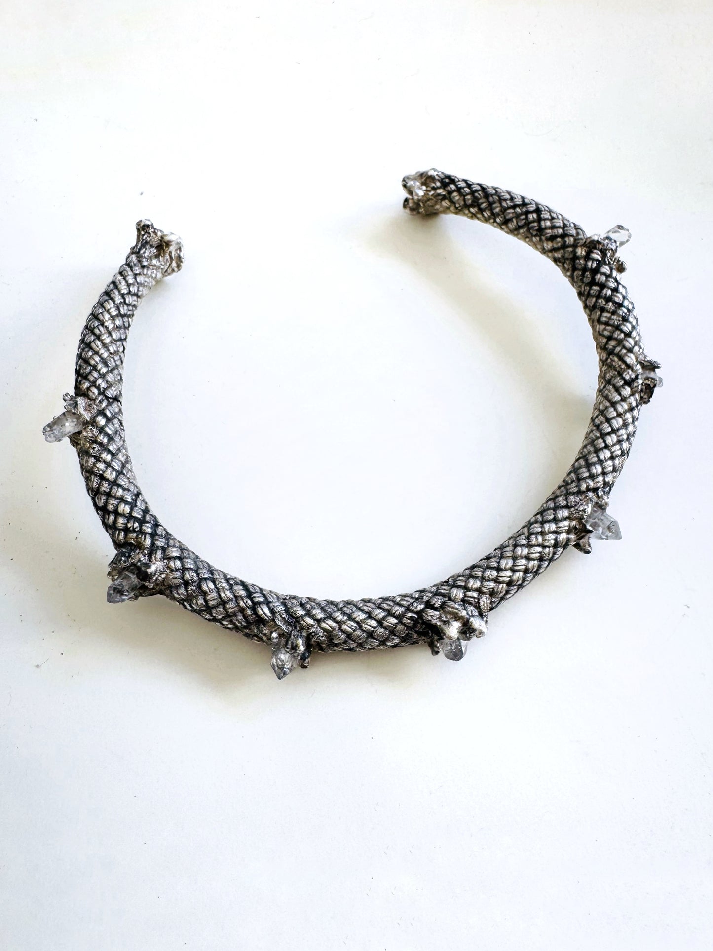 Silver necklace on a white background by Angela Lago